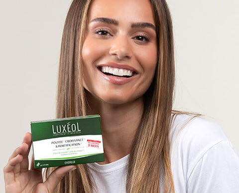 happy women with healthy hair holding supplements